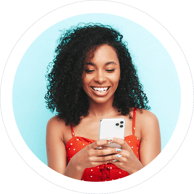 Photo of a woman in a red dress looking at a phone screen